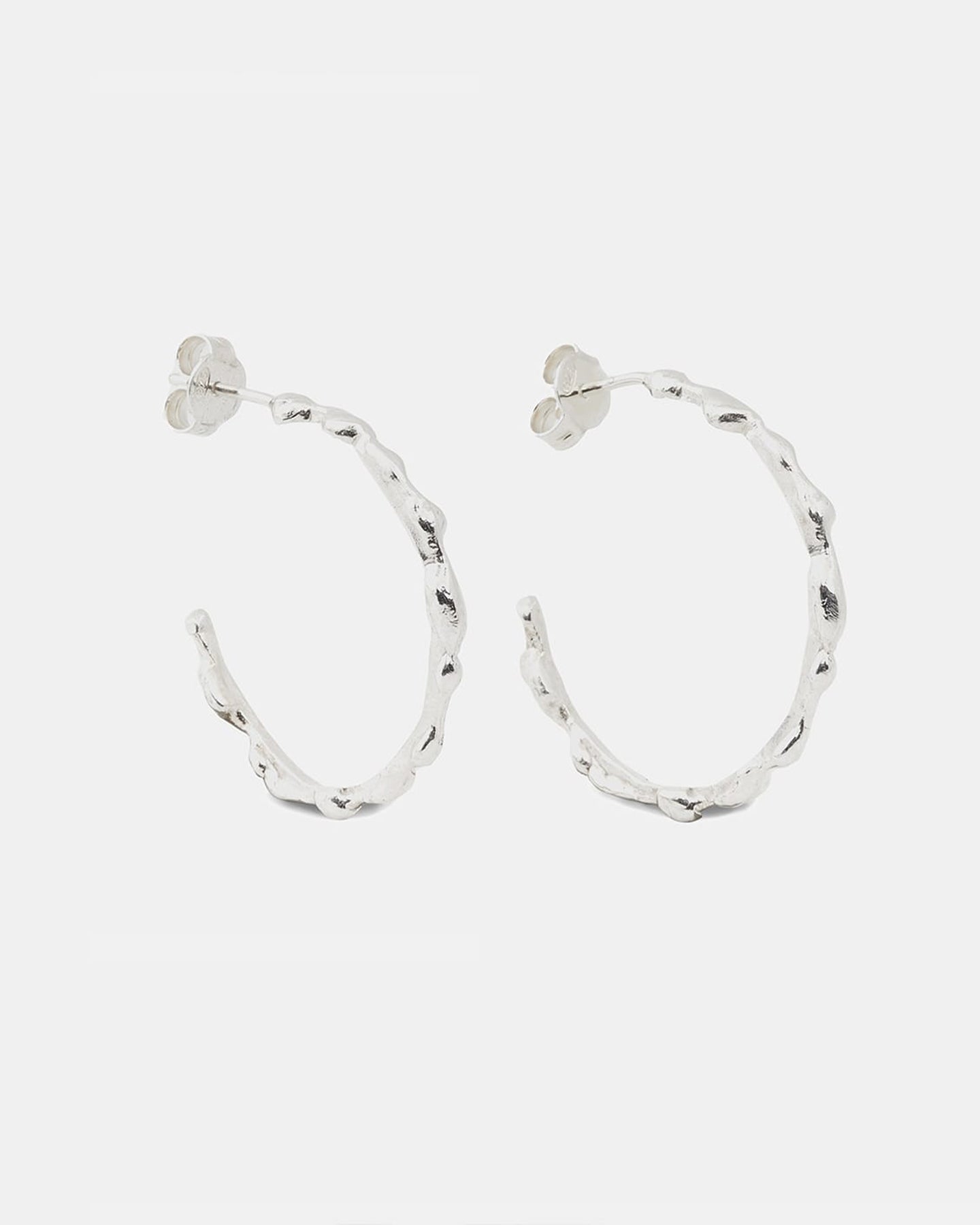 Silver drop earrings shown as a pair from a horizontal perspective.
