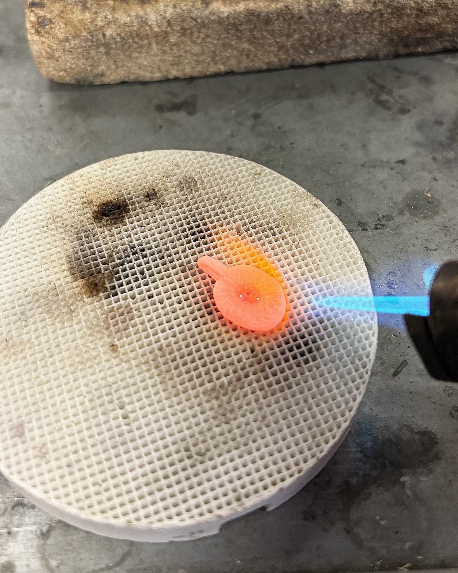flame firing a silver pendant during the LMJ silver clay workshop