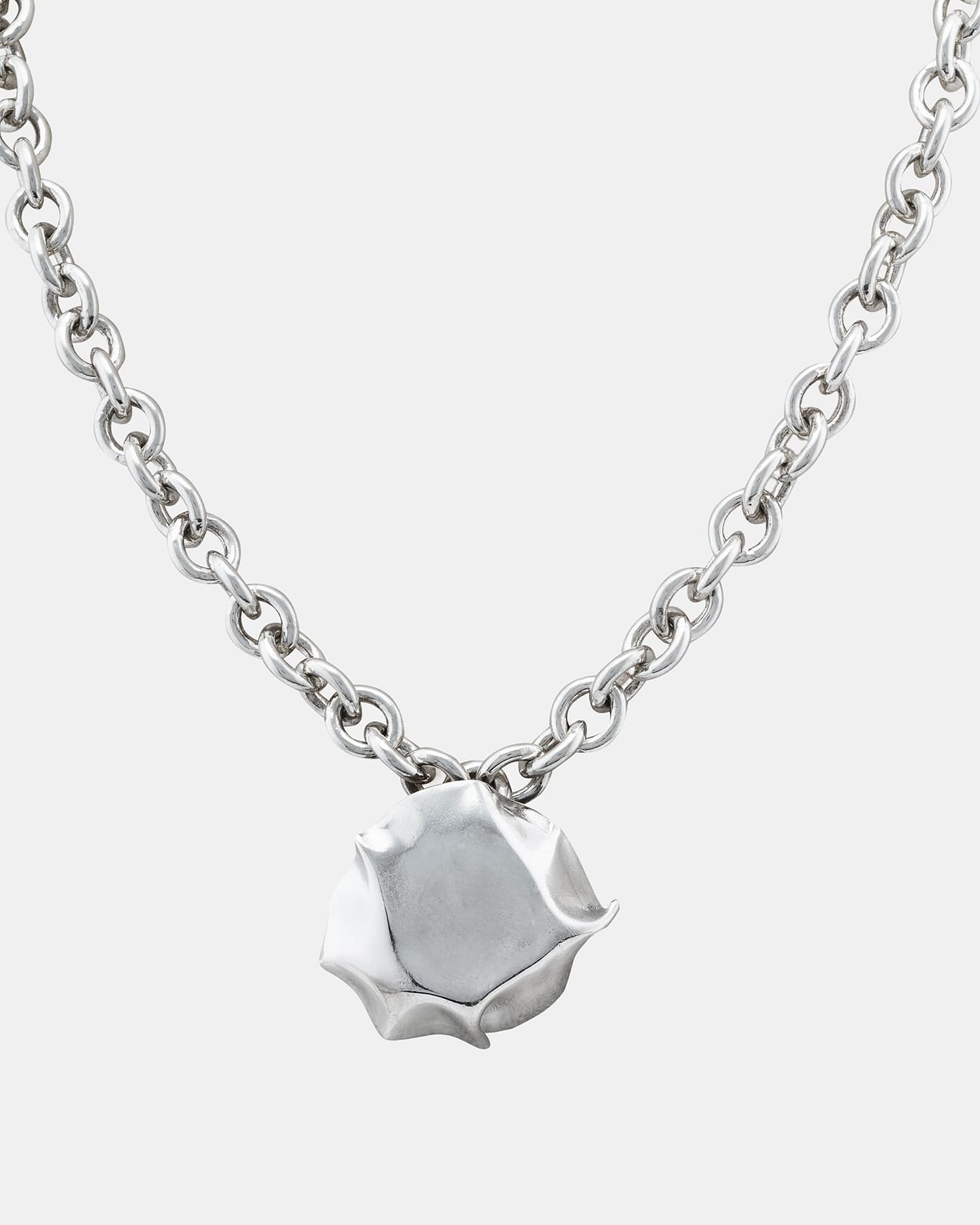 LMJ Blow Necklace in silver with sculptural pendant on chunky chain, laid flat.