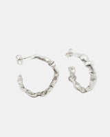 Sculptural silver LMJ Bubble Mini earrings shot in symmetry, showing off the high-shine surface.