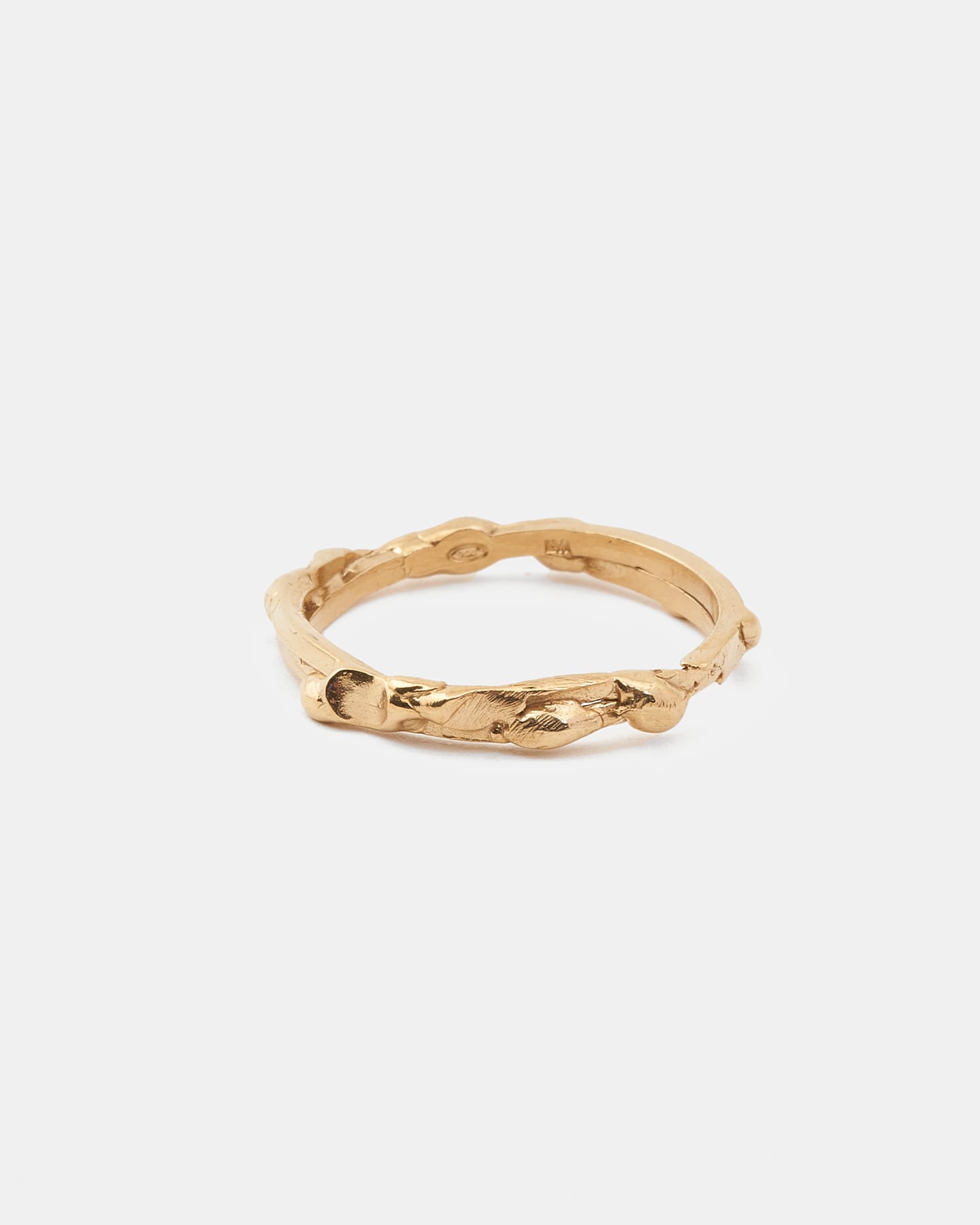 Gold drop ring in a horizontal front view with raw, organic surface.