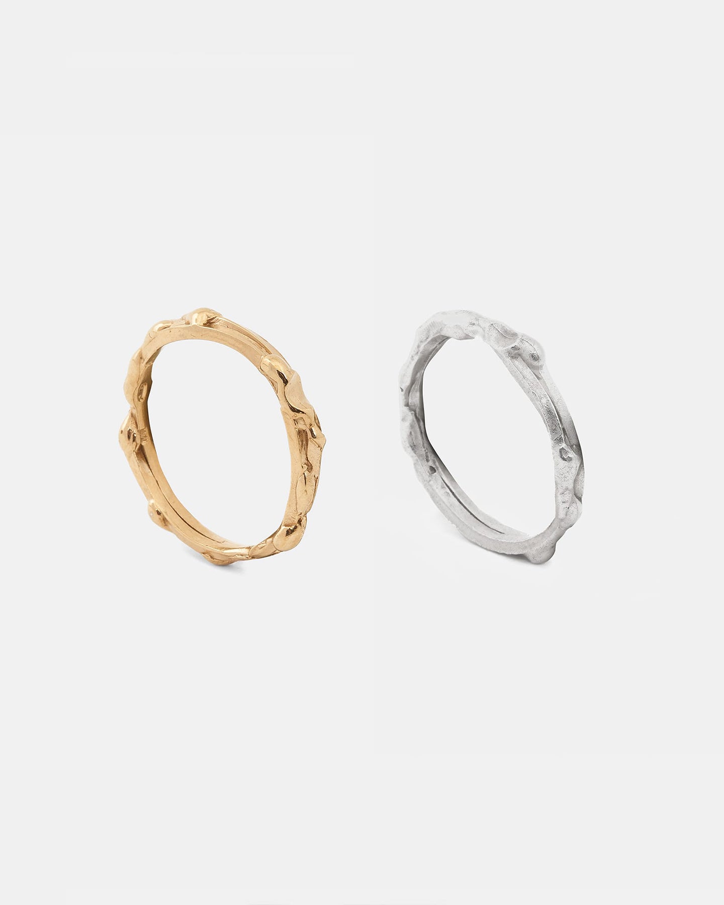 Gold and silver drop rings shown side by side, highlighting texture.