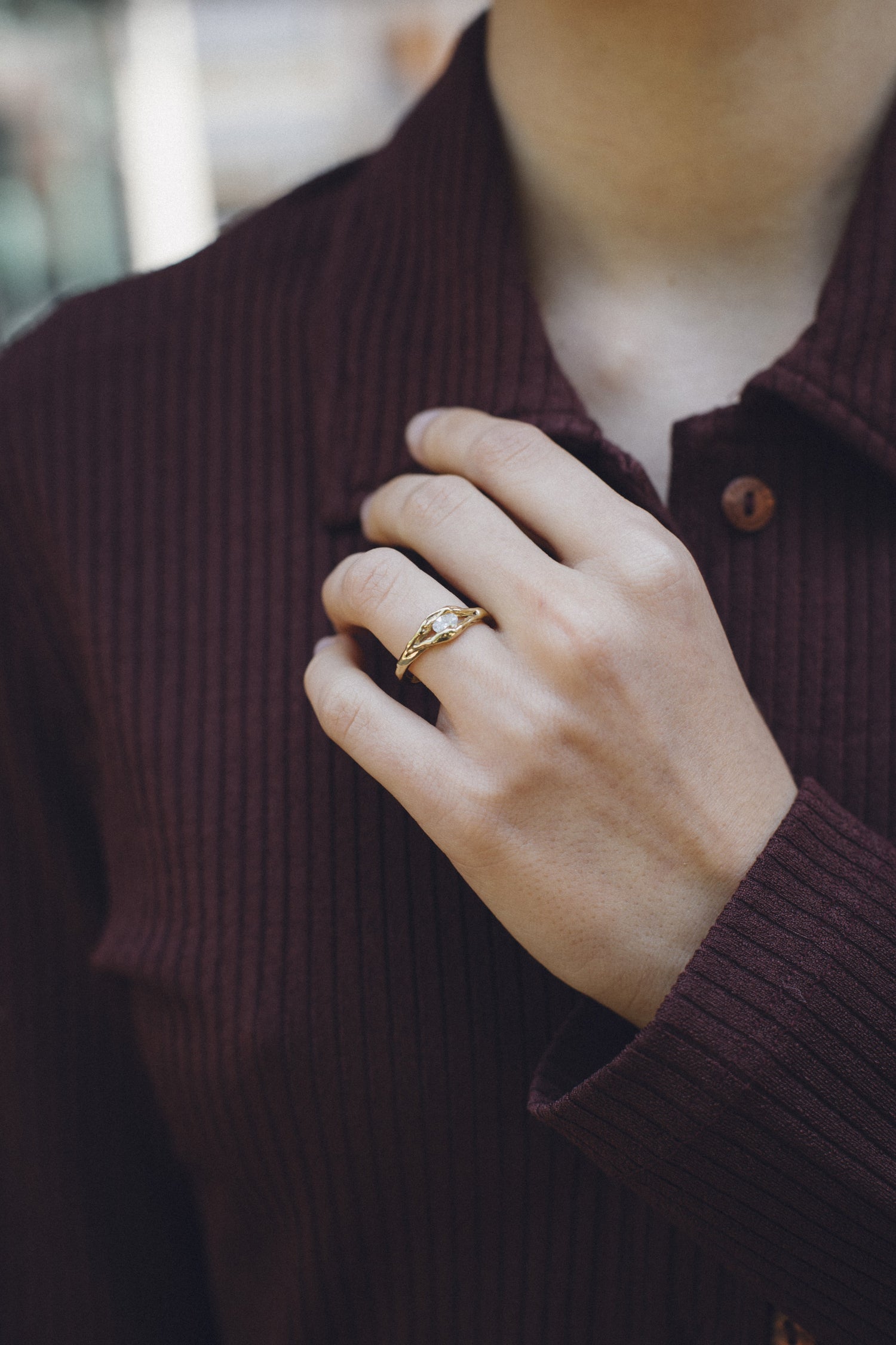 Nest Float Ring worn on a hand, 18k gold engagement ring with an oval diamond