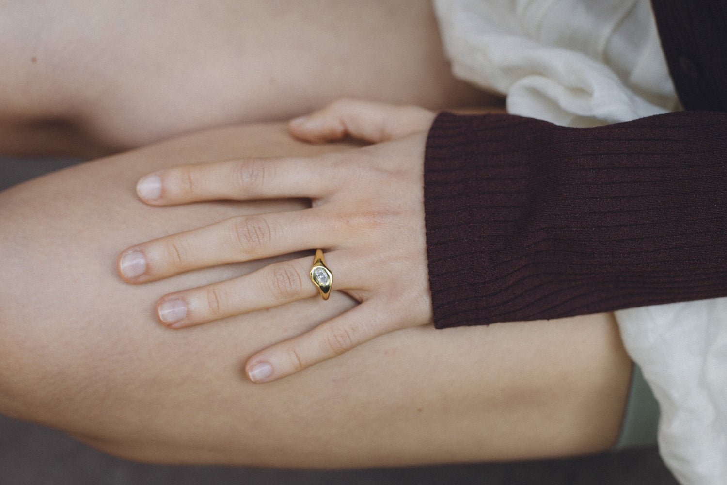 Orbit Midi Ring worn on a hand, 18k gold engagement ring with an oval diamond