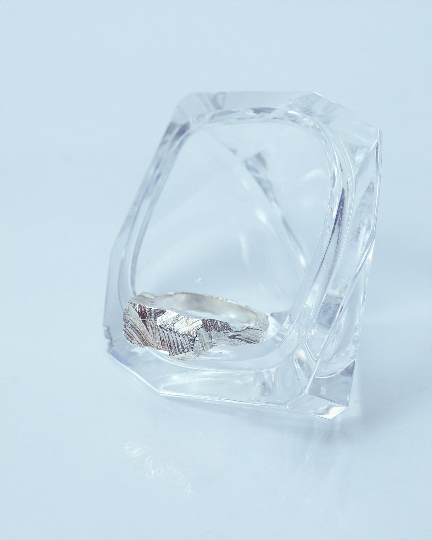 Latemar silver ring displayed in a geometric acrylic stand.