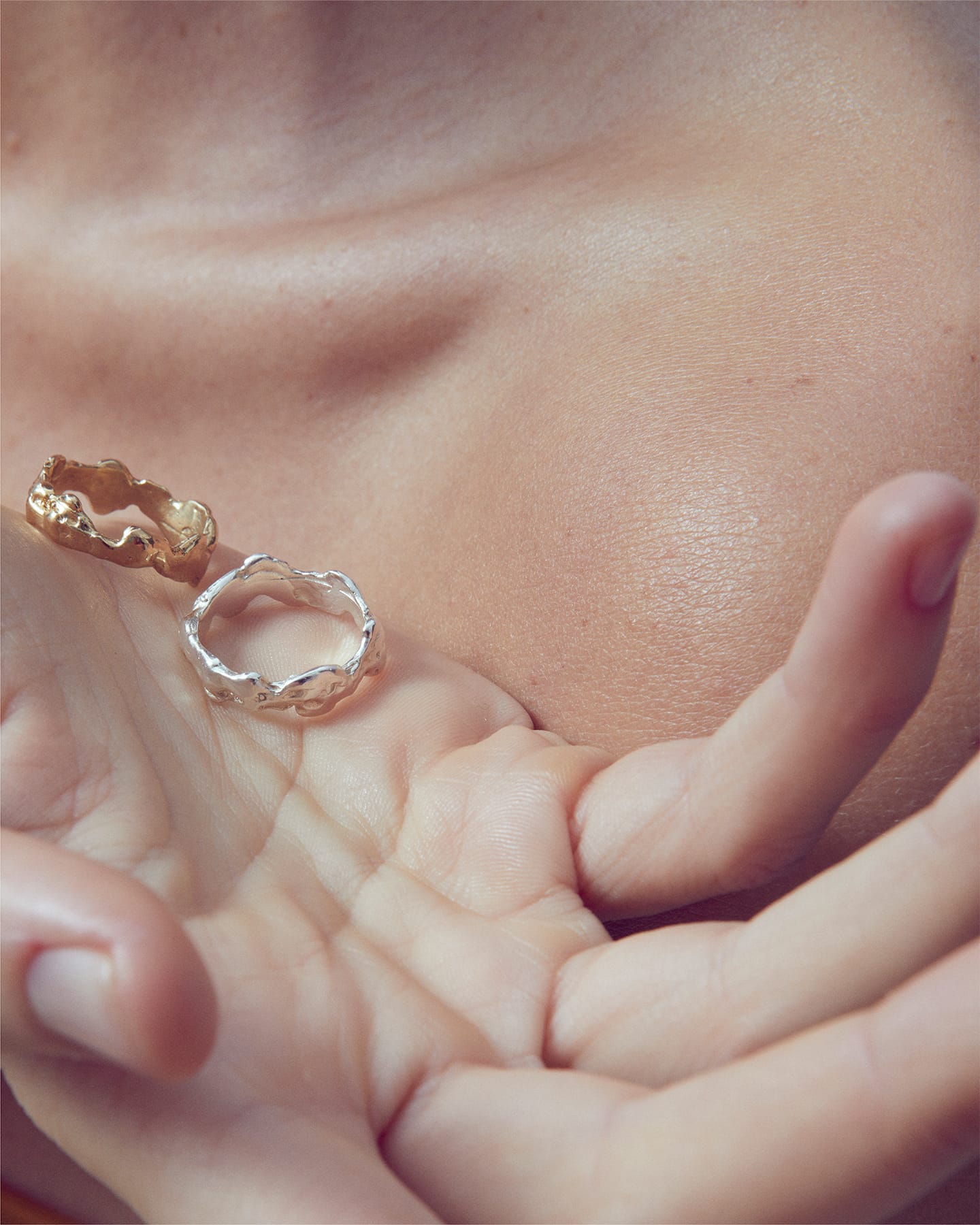 LMJ Lava Ring in Silver and gold hold by a hand 