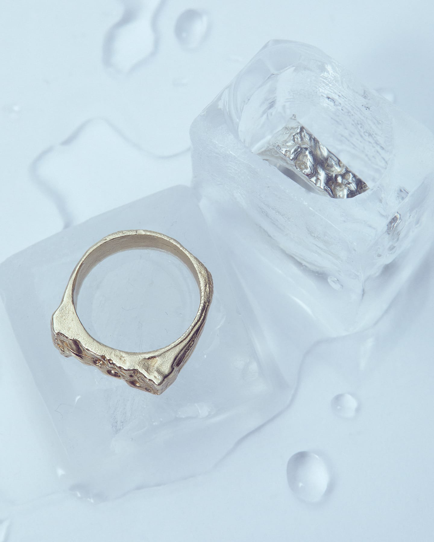 LMJ Lunar Gold ring on a textured white surface with ice