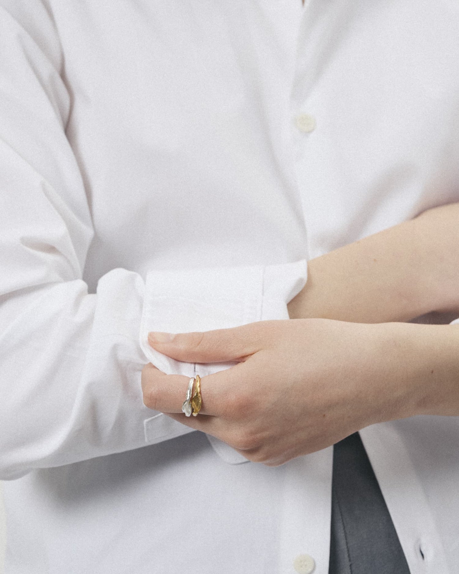Model wearing LMJ Petalo Mini Rings in mixed metals – graceful layering and tactile finish