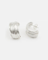 Model wearing LMJ Twist Earrings in silver – elegant sculptural curves