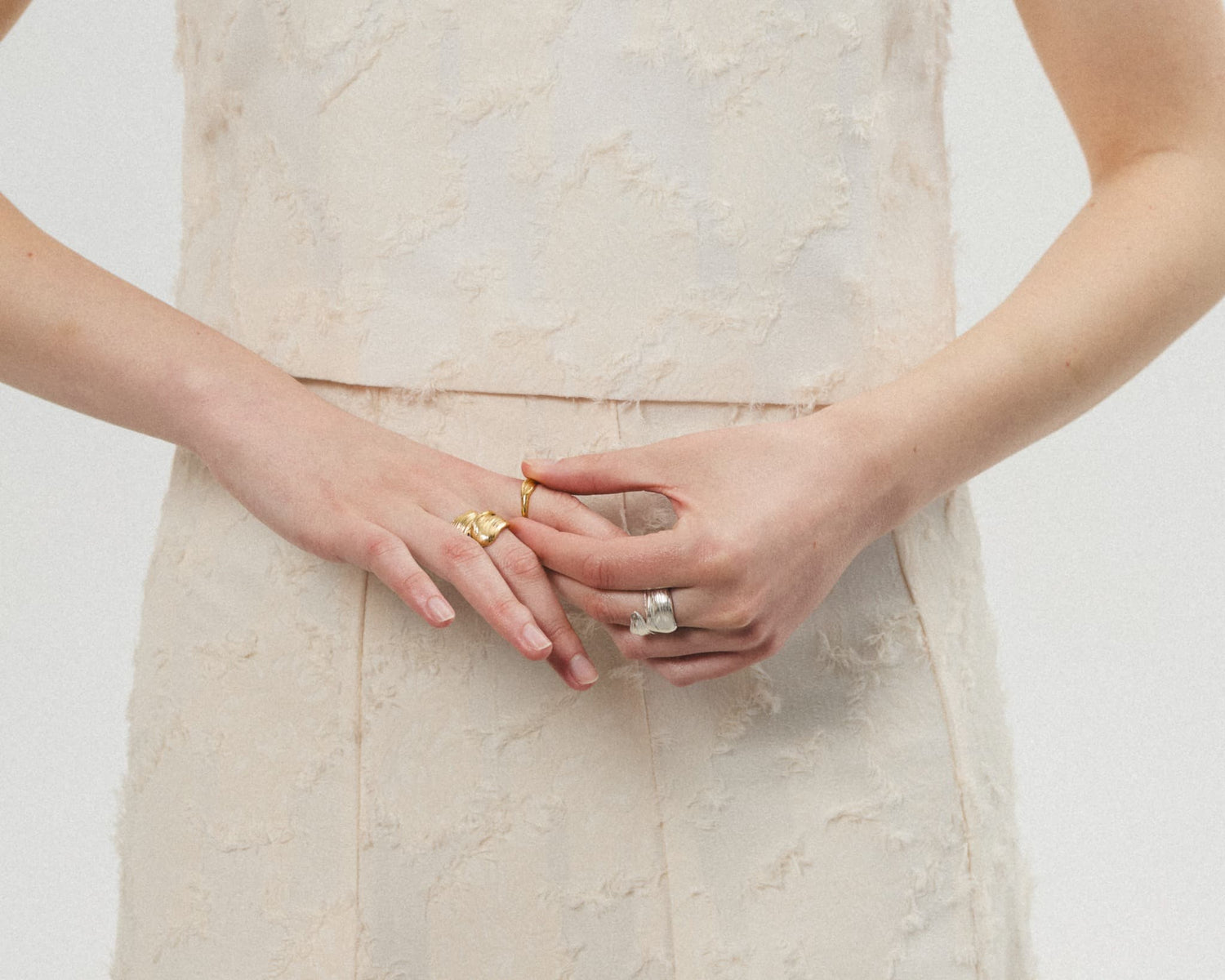 Model wearing LMJ Twist Ring in gold – sculpted movement captured in metal