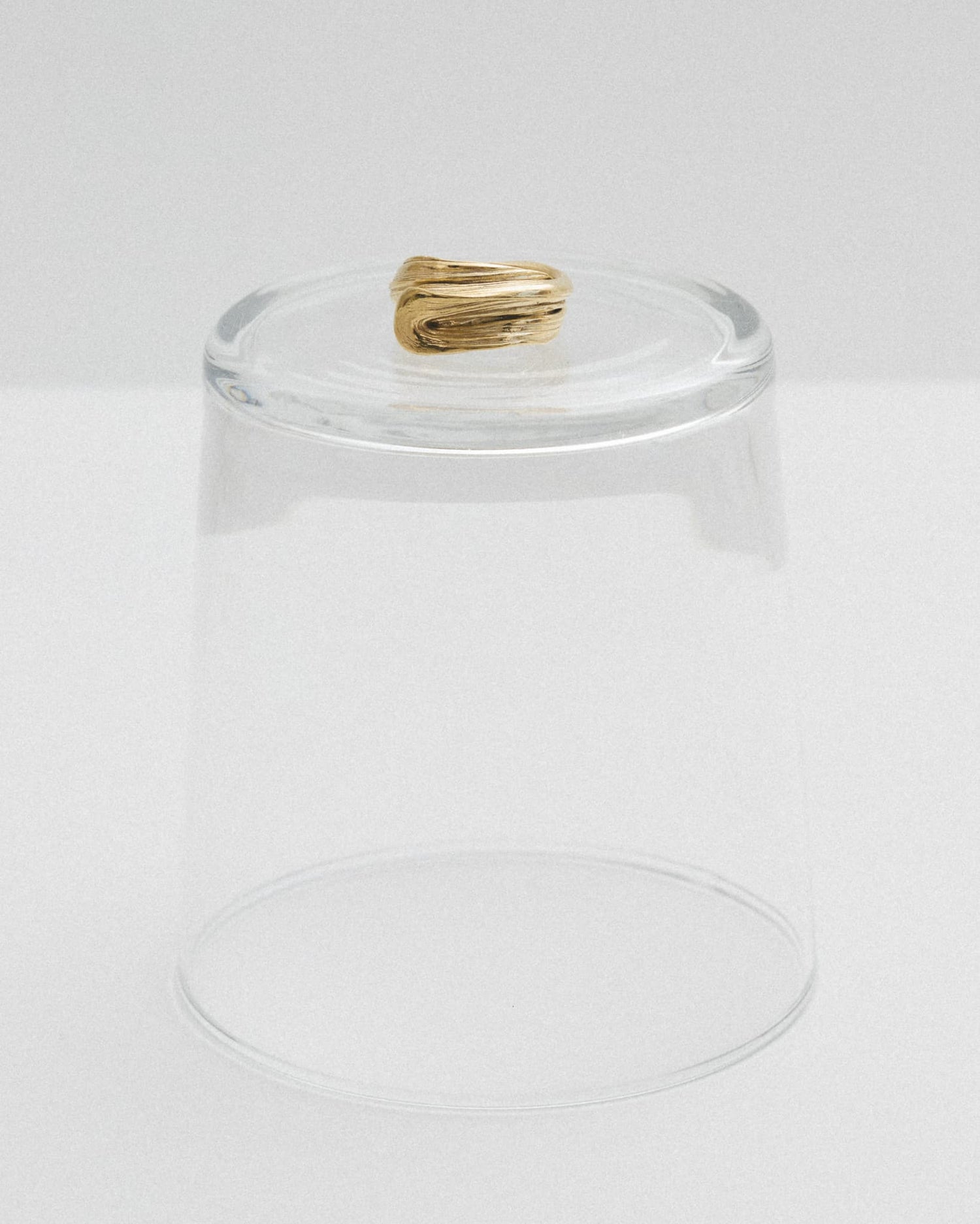 LMJ Vortex Ring in gold styled on a clear glass – floating elegance and soft curves